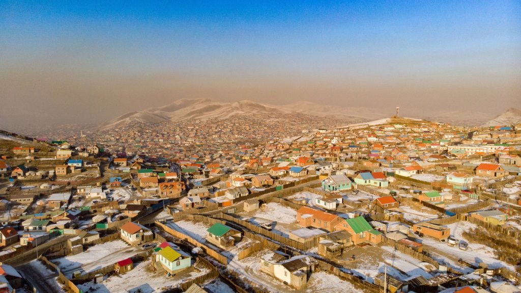 A thin line of smog hovers above the ger district in Ulaanbaatar. During winter, when temperatures drop to hazardous levels because of over-dependence on burning cheap raw coal for heating and cooking. A marked improvement in air quality in the city is expected after the government implemented a ban on raw coal in Ulaanbaatar in May 2019.